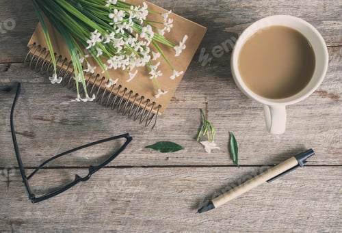 Preview: Cup of coffee with notebook on wooden table