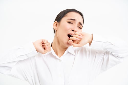 Preview: Tired businesswoman, korean entrepreneur yawns, feels tired, covers opened mouth with hand, stands
