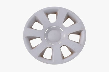 Preview: Worn Plastic Hubcap with Damage and Road Debris