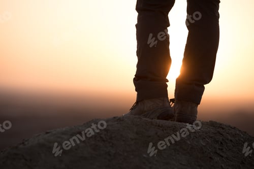 Preview: HikingSuccessful woman hiker enjoy the view on sand desert in the sunset