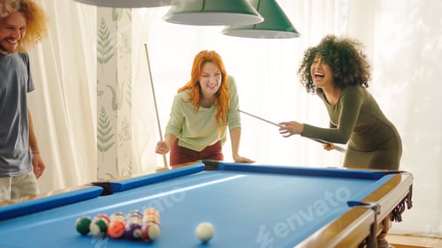 Preview: Friends laughing when woman playing awful at pool