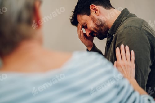 Vista previa: Sad young man talking about his mental health on a group therapy session