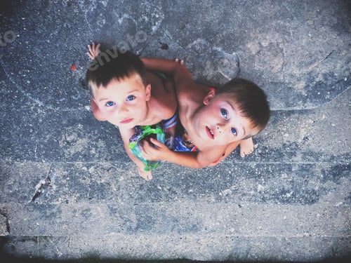 Preview: Two Young Children Look Upward Together