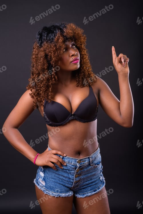 Preview: Young beautiful African woman against black background