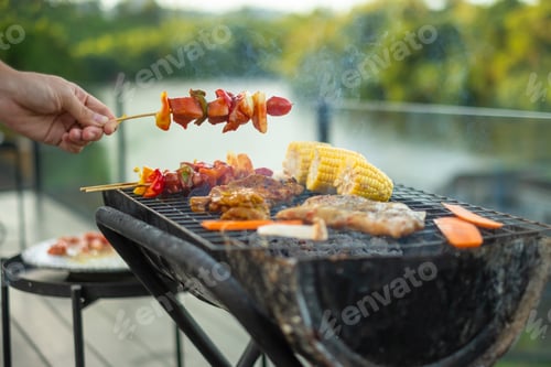 Preview: delicious grilled meat with smoke, BBQ with vegetables in outdoor. Barbecue, Party and picnic