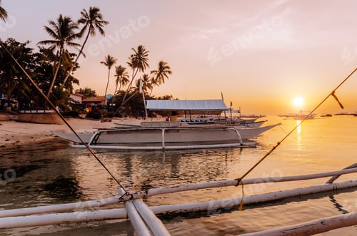 Preview: Sunset on the beach with silhouette of banca boat at Panglao Island, Bohol, Philippines