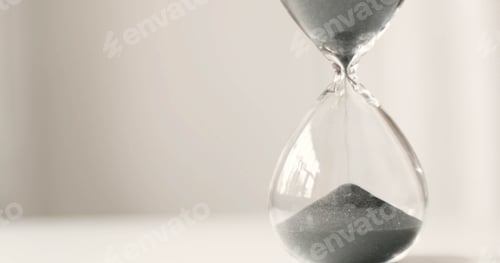 Preview: Modern hourglass in running time on a grey background
