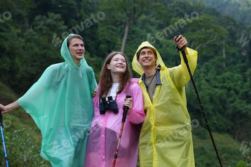 Preview: Hikers walking along a trail on a mountain with hiking sticks