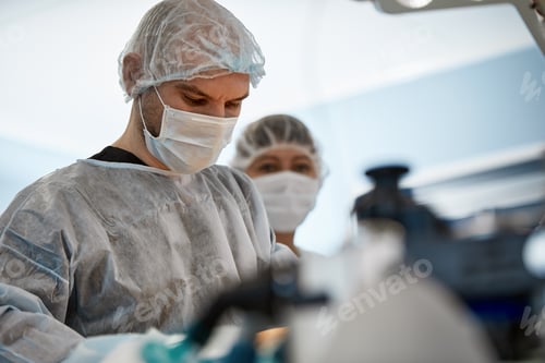 Preview: Surgeons in Masks and Protective Gear in Hospital