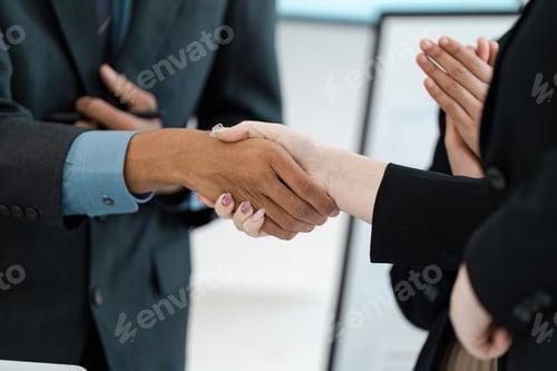 Preview: Handshake between business partners symbolizing collaboration and agreement.