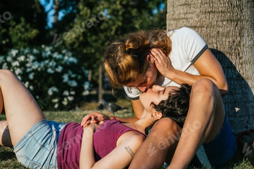Preview: Lesbian couple sharing a passionate kiss in the park