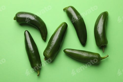 Preview: Ripe jalapeno peppers on light green background, flat lay