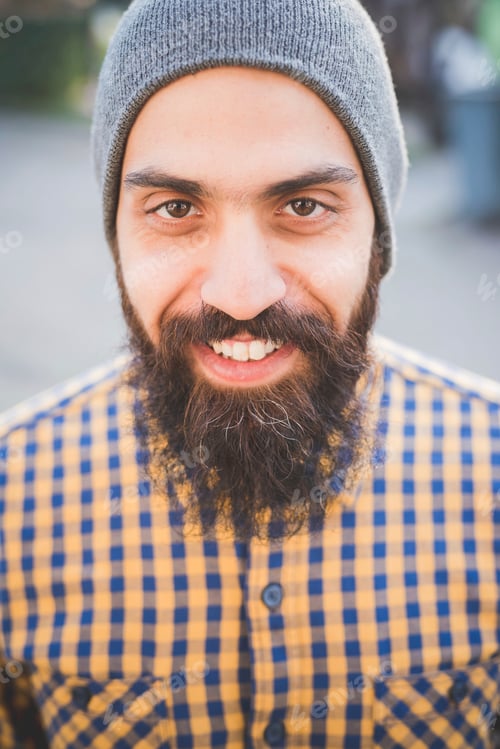 Preview: Portrait of mid adult man wearing beanie hat, outdoors