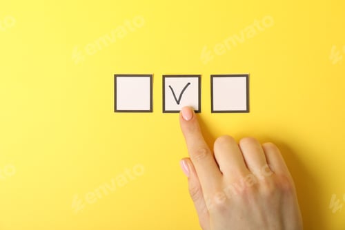 Preview: Woman pointing at checkbox with tick mark on yellow background, top view