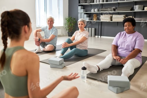 Preview: People talking to yoga instructor in class