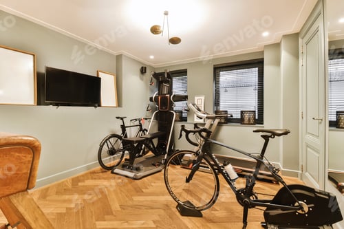 Preview: a home gym with two bikes and a tv on