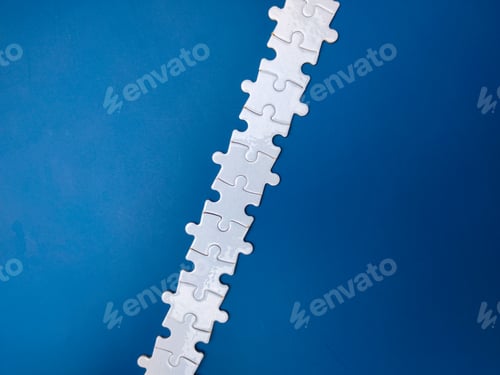 Preview: Unfinished white jigsaw puzzle pieces on blue background