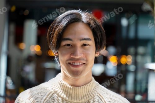Preview: Closeup portrait of asian man looking at camera. Positive japanese student posing for picture