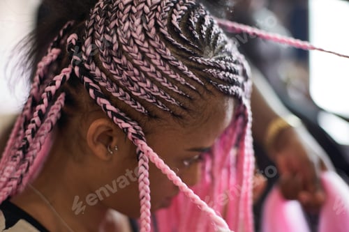 Preview: Young woman with pink braids, close-up