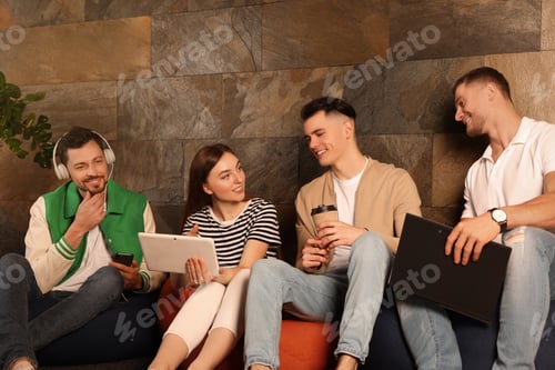 Preview: Office employees enjoying break together in recreation room at work