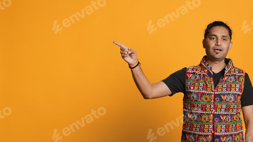 Preview: Salesman pointing around with finger showing copy text, studio background