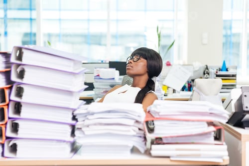 Preview: Businesswoman sleeping in office with many work