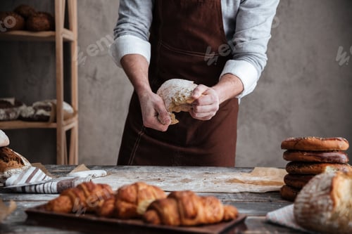 Preview: Cropped photo of young man baker