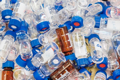 Preview: Dirty used chromatographic vials with blue caps. HPLC analysis at analytical chemistry laboratory