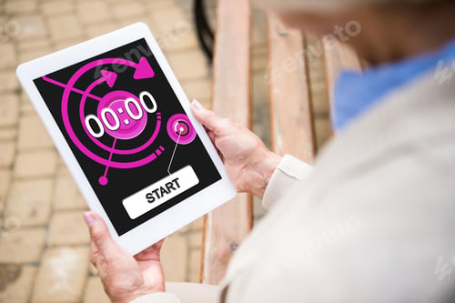 Preview: selective focus of senior woman using digital tablet with timer on screen