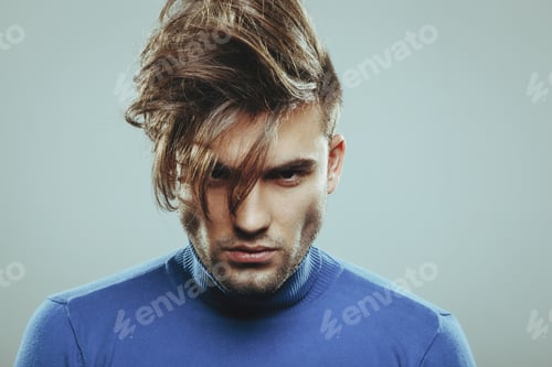 Preview: Handsome man with modern hairstyle in studio
