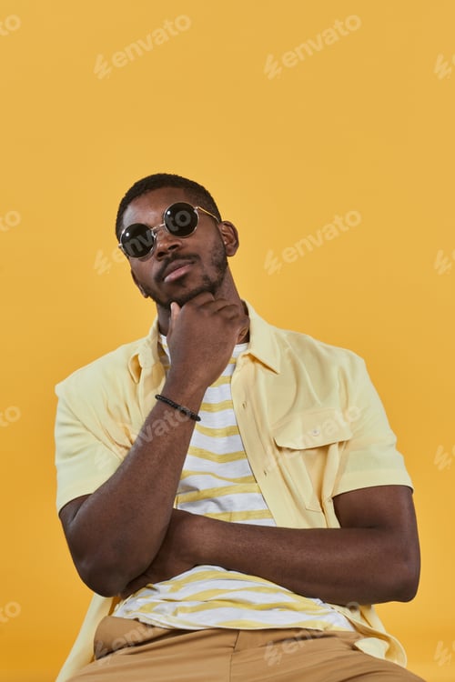 Preview: Man with Sunglasses Poses in Yellow Shirt