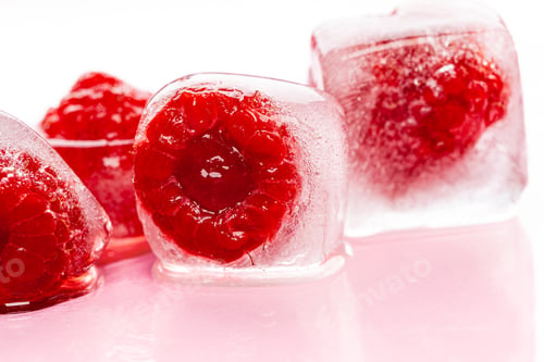 Preview: Raspberry ice cubes on pink glossy background