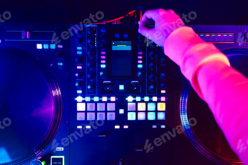 Preview: Hands of a DJ creating and regulating music on dj console mixer at club concert