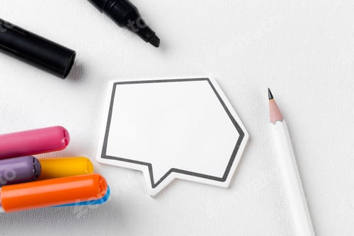 Preview: Colorful markers and a speech bubble on a white background for creative projects