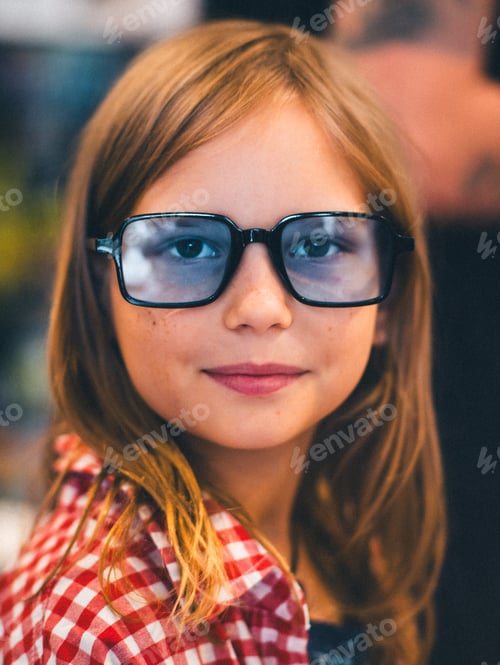 Preview: Close-up Portrait of Teenager Girl Wearing Blue Glasses with Warm Smile