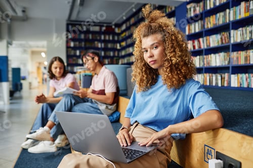 Preview: Young Girl Studying in Library