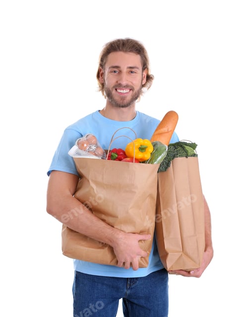 Preview: Delivery man holding paper bags with food products on white background