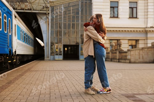 Preview: Goodbye. Lovely couple hugging near train outdoors, space for text