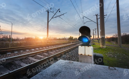 Preview: Railway station with semaphore against beautiful sky at sunset