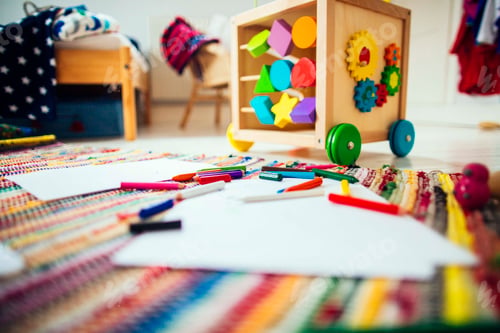Preview: Colored pencils and drawing papers on carpet at home