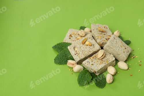 Preview: Concept of tasty food with halva on green background