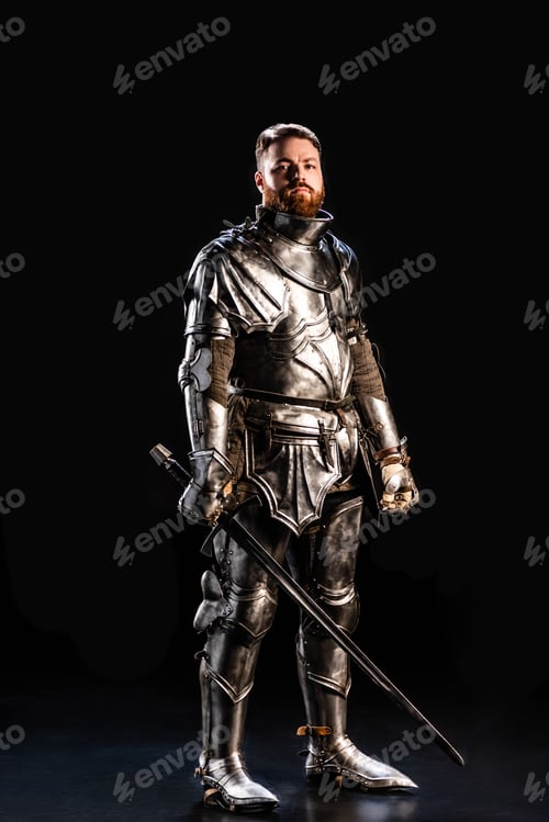 Preview: handsome knight in armor holding sword isolated on black