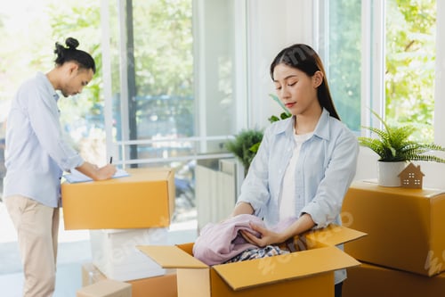 Preview: An Asian couple is helping each other pack their belongings to move to a new house