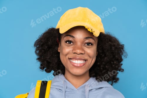 Preview: Young black woman smiling while posing with backpack