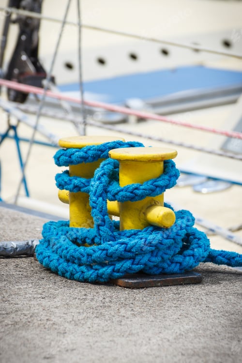 Preview: Thick blue rope and yellow bollards on wharf using for anchorage of yachts