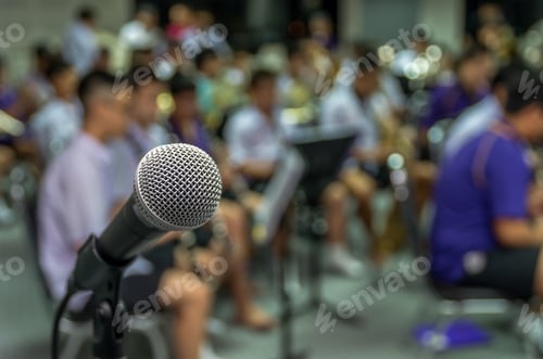 Preview: Microphone over the Abstract blurred photo of classic music band when rehearsal