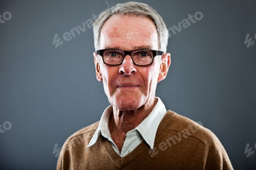 Preview: Expressive Good Looking Senior Man Wearing Glasses Against Grey Wall. Funny And Characteristic
