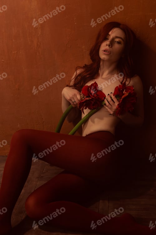 Preview: Beautiful Girl With Red Hair, Makeup And Styling. Red Flowers In The Hands