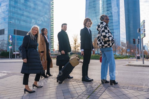 Preview: Group of multi-ethnic business people with suitcases attending a conference in a business park