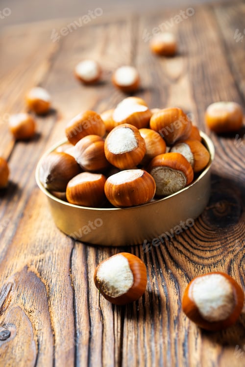 Preview: Hazelnuts on wooden backdrop. heap or stack of hazelnuts. Hazelnut background, healty food